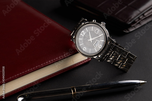 business time management concept. male luxury watch at workplace.