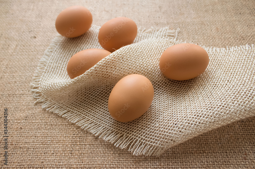 Close up of fresh organic chicken eggs from farmer market on linen tablecloth, selective focus Close up of fresh organic chicken eggs from farmer market on linen tablecloth, selective focus