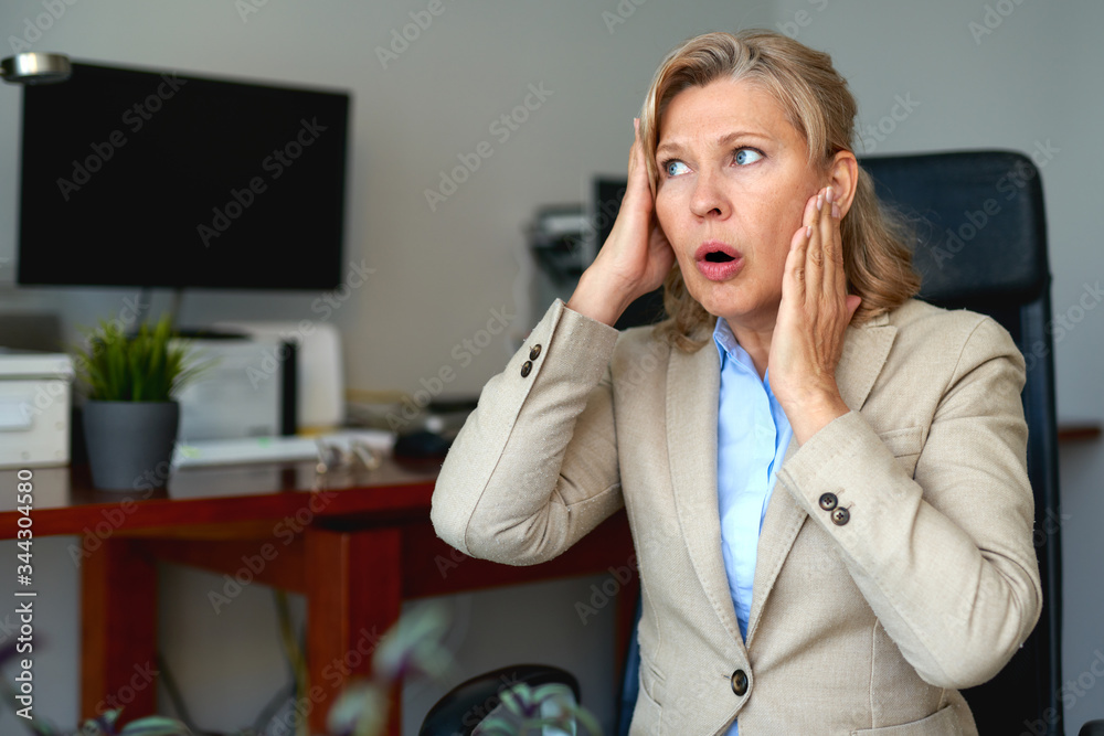 Portrait of mature female boss working in office. Portrait of mature female boss working in office.