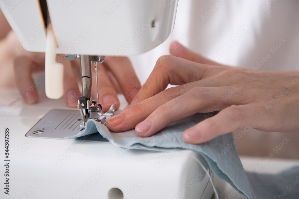 woman hands cooking with blue fabric machine