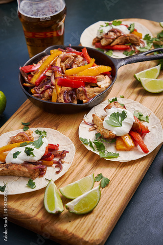 Wallpaper Mural Mexican fajitas served on a wooden board on a table Torontodigital.ca