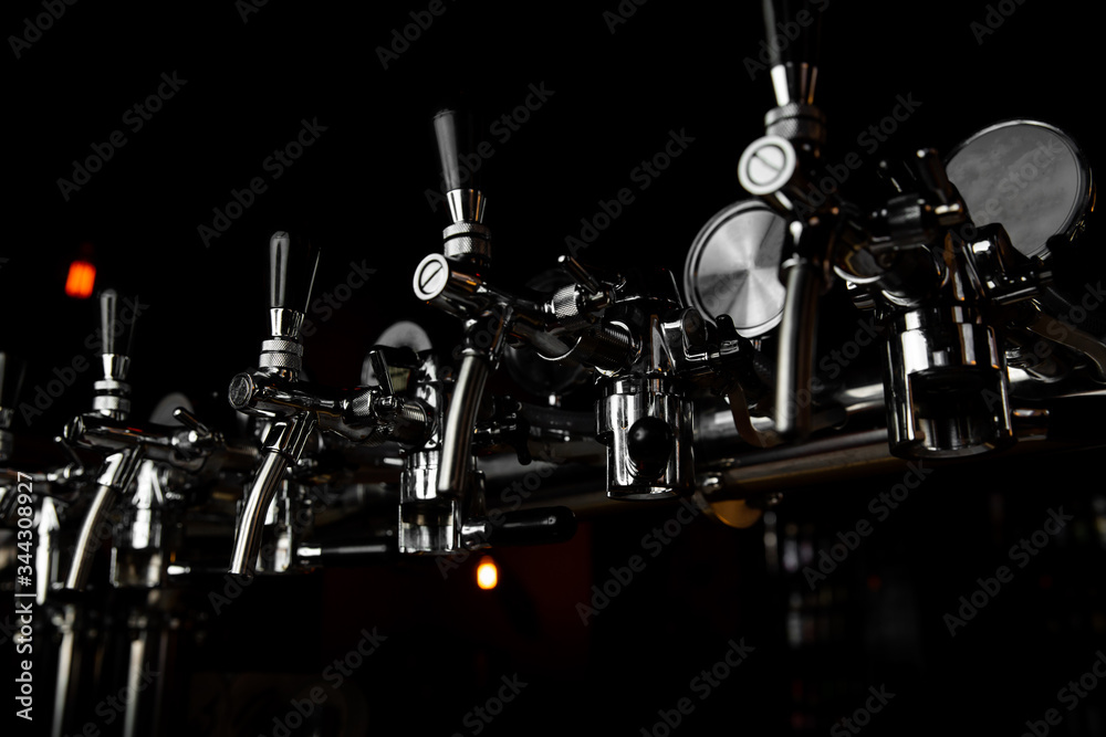 Beer taps bar brewery pints. many beer taps in bar or pub Beer taps bar brewery pints. many beer taps in bar or pub