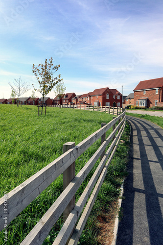 Wooden fence and footpath leading to new homes
