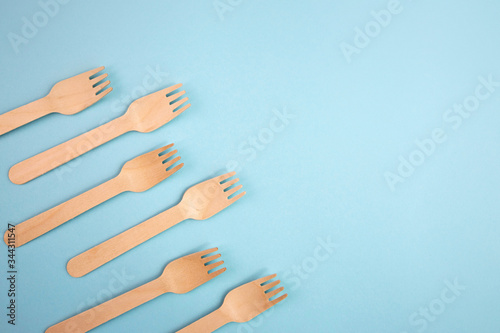 look from above. wooden forks. eco friendly concept. copy space. eco friendly disposable kitchenware utensils on paper background. ecology  zero waste concept. top view. flat lay.