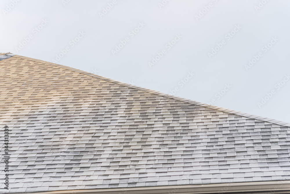 Morning light and frost on black shingle roof of residential house under clear blue sky near Dallas, Texas, USA Morning light and frost on black shingle roof of residential house under clear blue sky near Dallas, Texas, USA