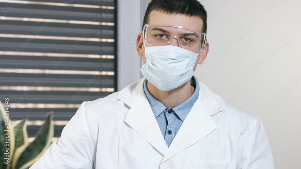 Young male doctor scientist with mask portrait in hospital