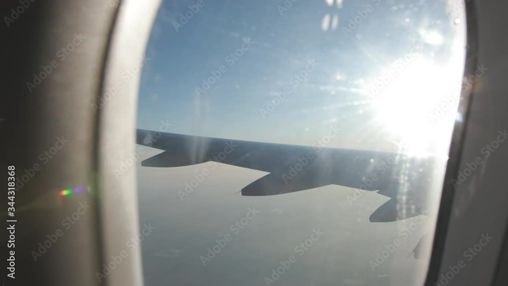 view through plane altitude, in flight, sunlight and a little fog view through plane altitude, in flight, sunlight and a little fog