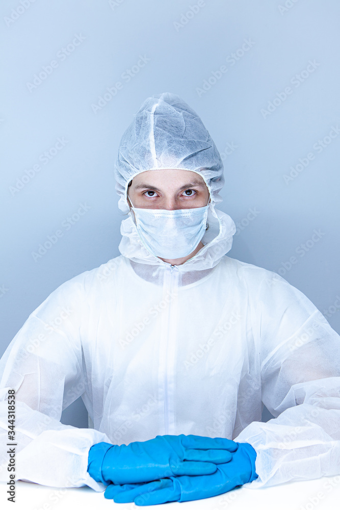 a man in a protective suit, gloves and face mask. The concept of health care.
