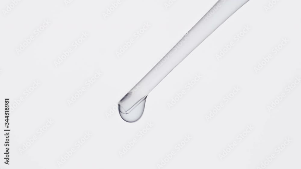 Liquid drop from laboratory pipette at white background. Medical and chemistry laboratory research. Close-up in 4K, UHD Liquid drop from laboratory pipette at white background. Medical and chemistry laboratory research. Close-up in 4K, UHD