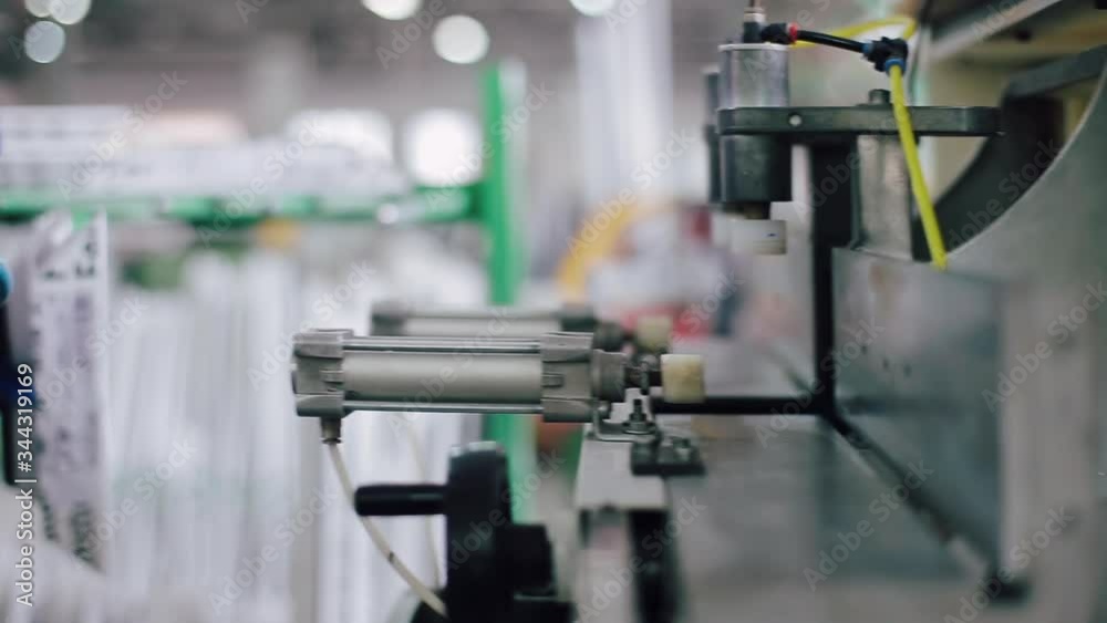 Manual worker assembling PVC doors and windows. Factory for PVC windows and doors production. Workers in workshop. Manual worker assembling PVC doors and windows. Factory for PVC windows and doors production. Workers in workshop.