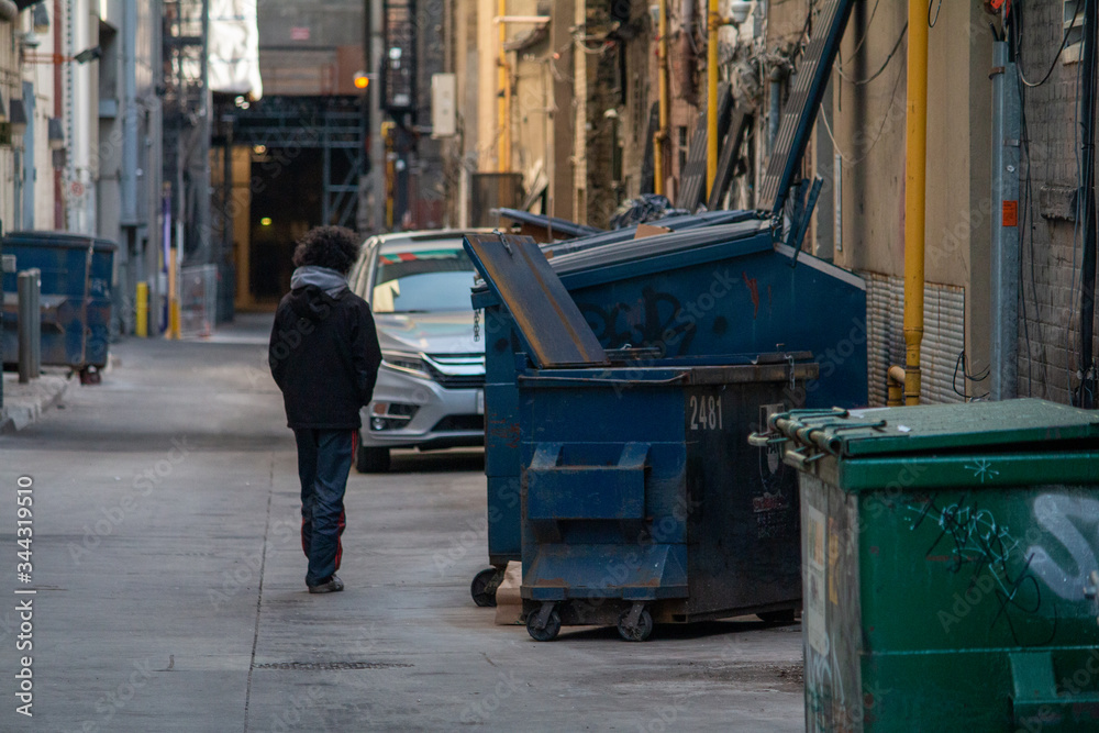 Man walking down a painted alley in Toronto. Man walking down a painted alley in Toronto.