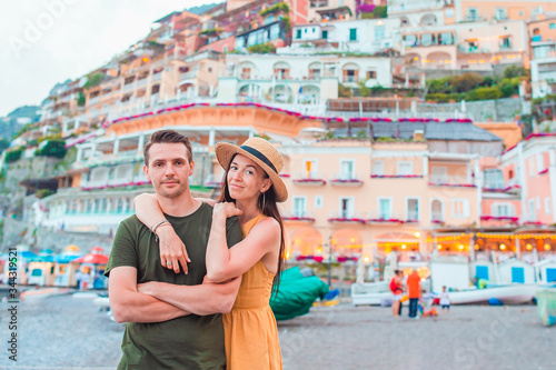 Summer holiday in Italy. Young couple in Positano village on the background, Amalfi Coast, Italy © travnikovstudio