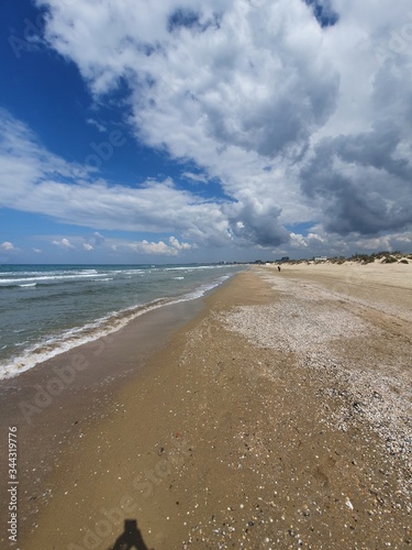 A deserted beach on a cloudy day. You can see the heart in the clouds. Spring romantic photo. The beach in anticipation of summer. Black sea in good weather.