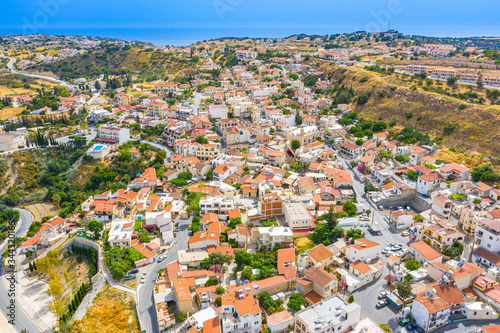 The village of Pissouri in Cyprus. White houses with terracotta roofs were photographed from a height. Resort places of the Republic of Cyprus. Vacation on the Mediterranean coast. photo