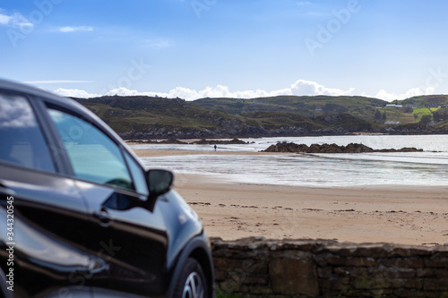 Fintra Beach. Ireland April 2019.  black car parked in front of a beautiful empty beach in county donegal.