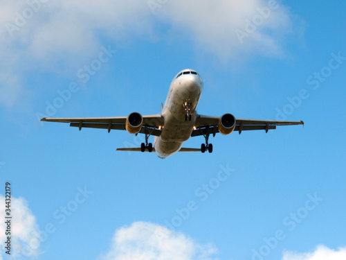 plane landing on a sunny day with blue sky