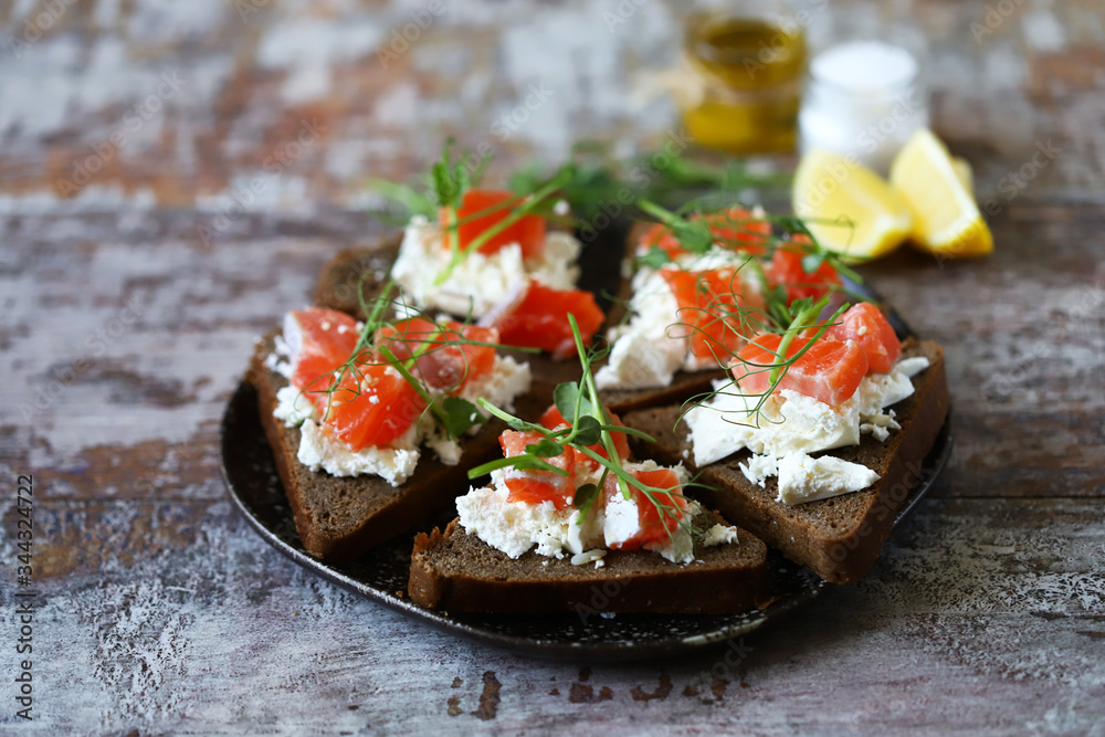 Selective focus. Macro. Healthy toasts with salmon and microgreens. Selective focus. Macro. Healthy toasts with salmon and microgreens.