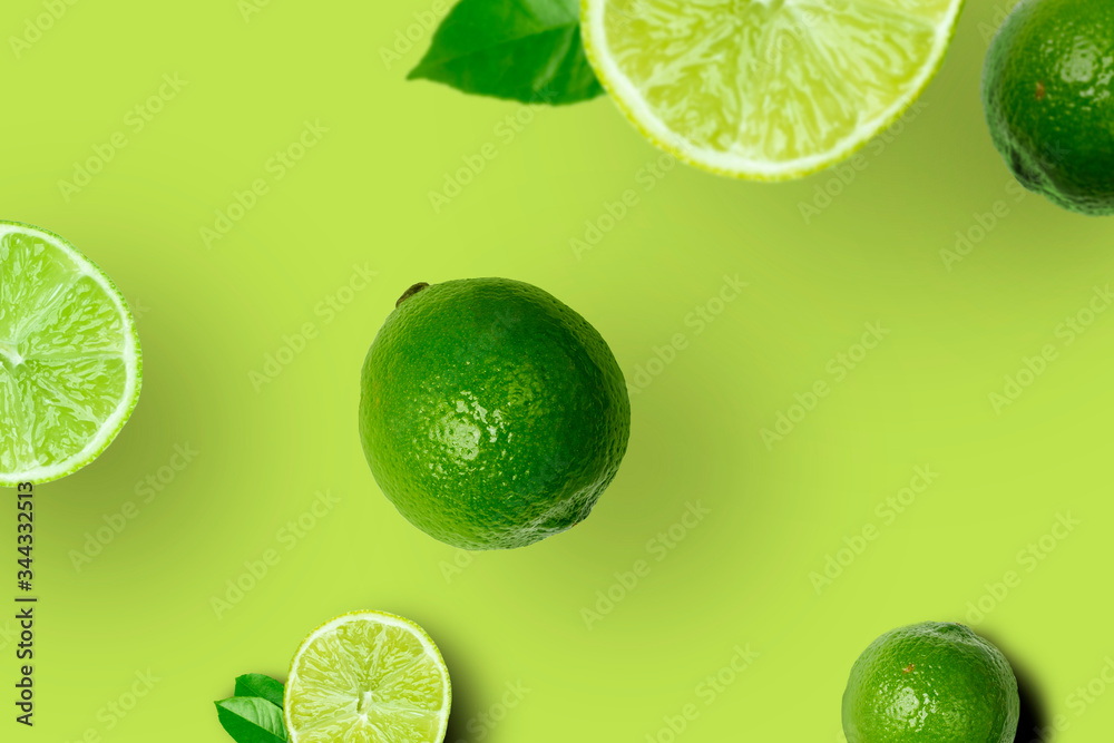 Set of Fresh Ripe Whole and Cut Limes With Leaves and Slices on Bright Green Background. Top View