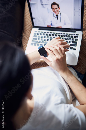 Cropped photo of Caucasian sick woman checking time