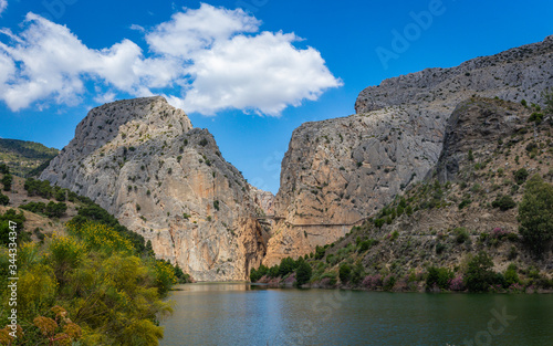 El Chorro reservoir, Caminito del Rey (The Gorge Desfiladero de los Gaitanes). Panorama of a lake, mountains and clouds.