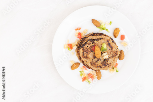 Flat lay American pancakes with banana and dried fruits and copy space