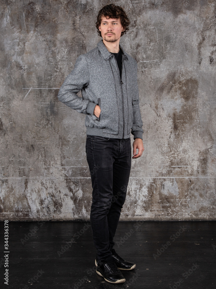 Studio portrait of attractive young man. Young Male Fashion Model Posing In Casual Outfit. 