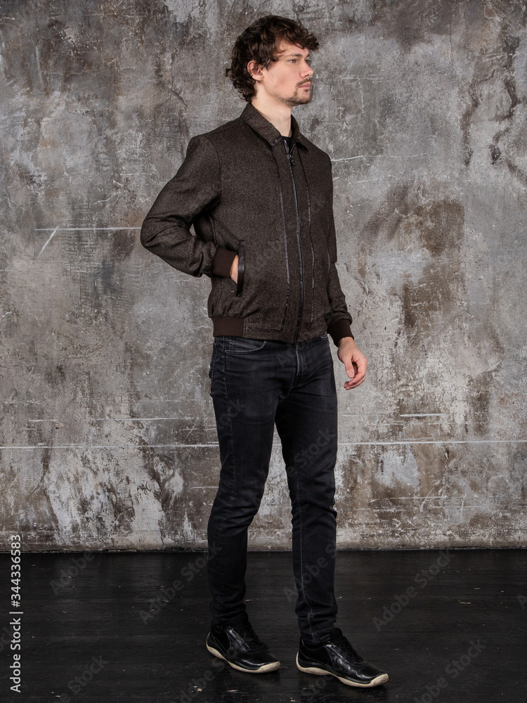 Full length studio portrait of attractive young man. Young Male Fashion Model Posing In Casual Outfit. Full length studio portrait of attractive young man. Young Male Fashion Model Posing In Casual Outfit.