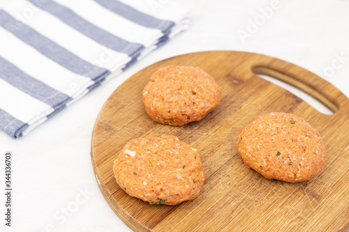 Raw minced meat meatballs on the wooden board ready for frying