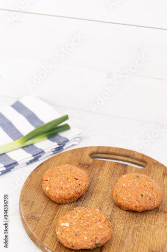Raw minced meat meatballs on the wooden board ready for frying