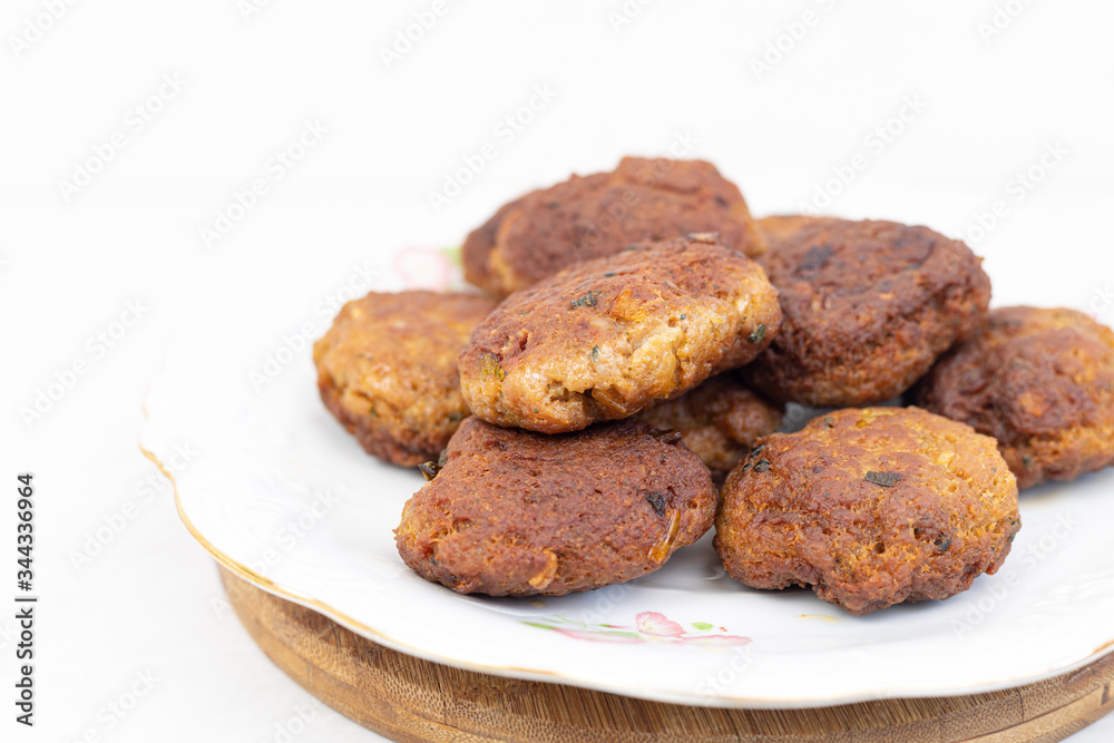 Fried meatballs served on the plate with white background