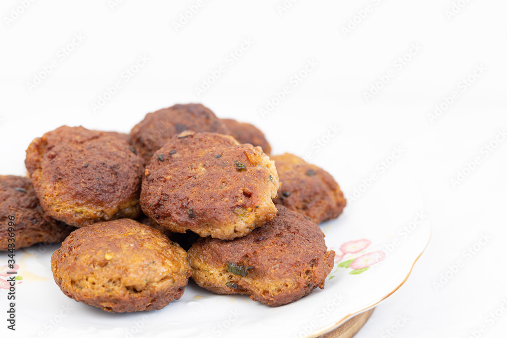 Fried meatballs served on the plate with white background and copy space Fried meatballs served on the plate with white background and copy space
