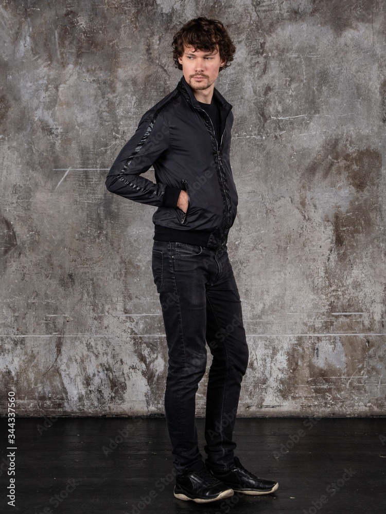 Full length studio portrait of attractive young man. Young Male Fashion Model Posing In Casual Outfit. Full length studio portrait of attractive young man. Young Male Fashion Model Posing In Casual Outfit.