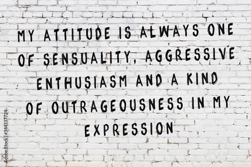 Painted black mindful inscription on white brick wall background photo