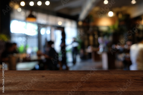 Wallpaper Mural wood table on blur of cafe, coffee shop, bar, resturant, background - can used for display or montage your products Torontodigital.ca