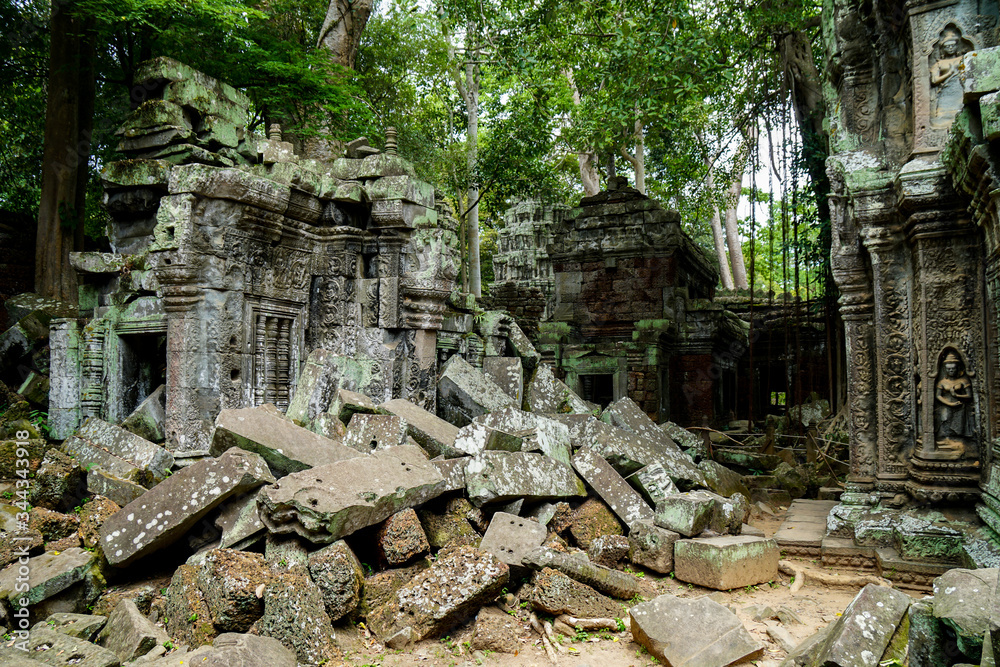 the ruins of an ancient temple Preah Khan, green stones lie in a pile, walls and columns, Big Circle of Angkor Wat complex, building lost in the jungle