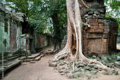 the ruins of an ancient temple Preah Khan, green stones lie in a pile, walls and columns, Big Circle of Angkor Wat complex, building lost in the jungle photo