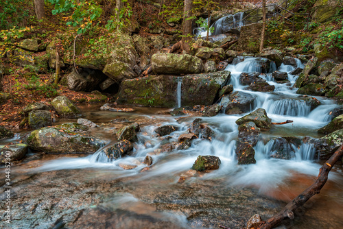 Fototapeta Naklejka Na Ścianę i Meble -  Long Exposure shot of Crabtree Falls in Virginia, cascade water fall flowing over the rocks in forest