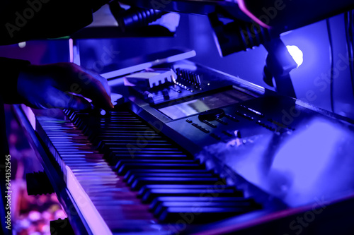 Piano Player or Keyboard Musician performing live at concert showing keys