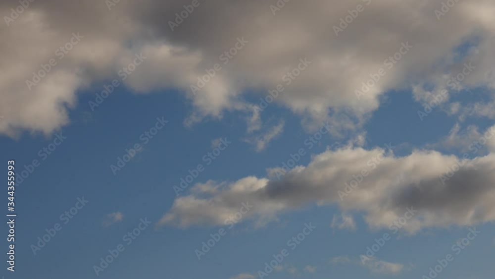 Blue sky, white rolling, fast motion time lapse clouds in horizon Blue sky, white rolling, fast motion time lapse clouds in horizon
