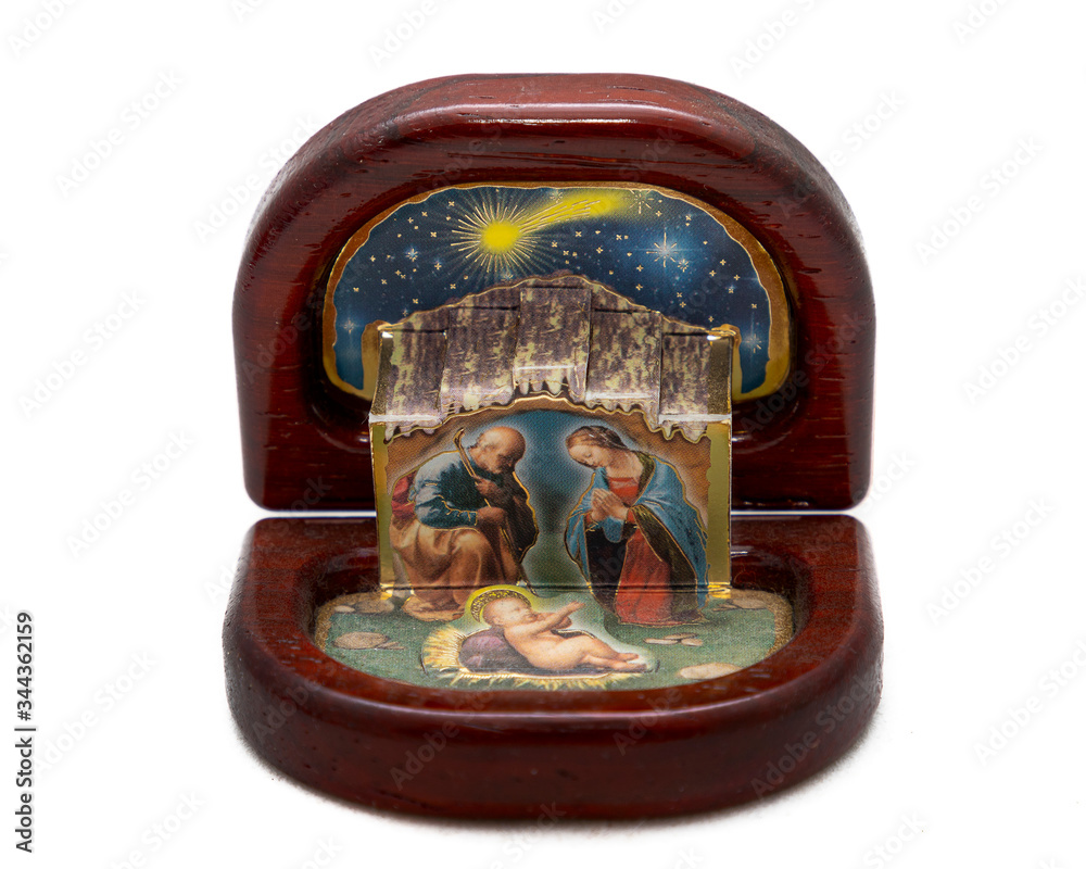 antique Christmas nativity scene decoration on white background, wooden case with painted holy family 
