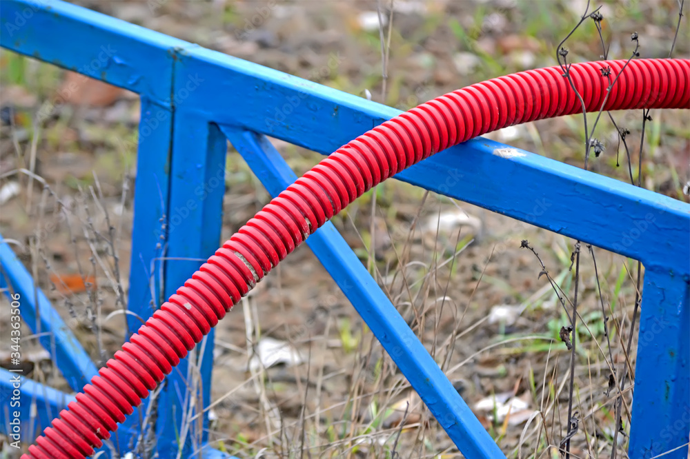 red plastic pipe garbage on blue construction, environment diversity