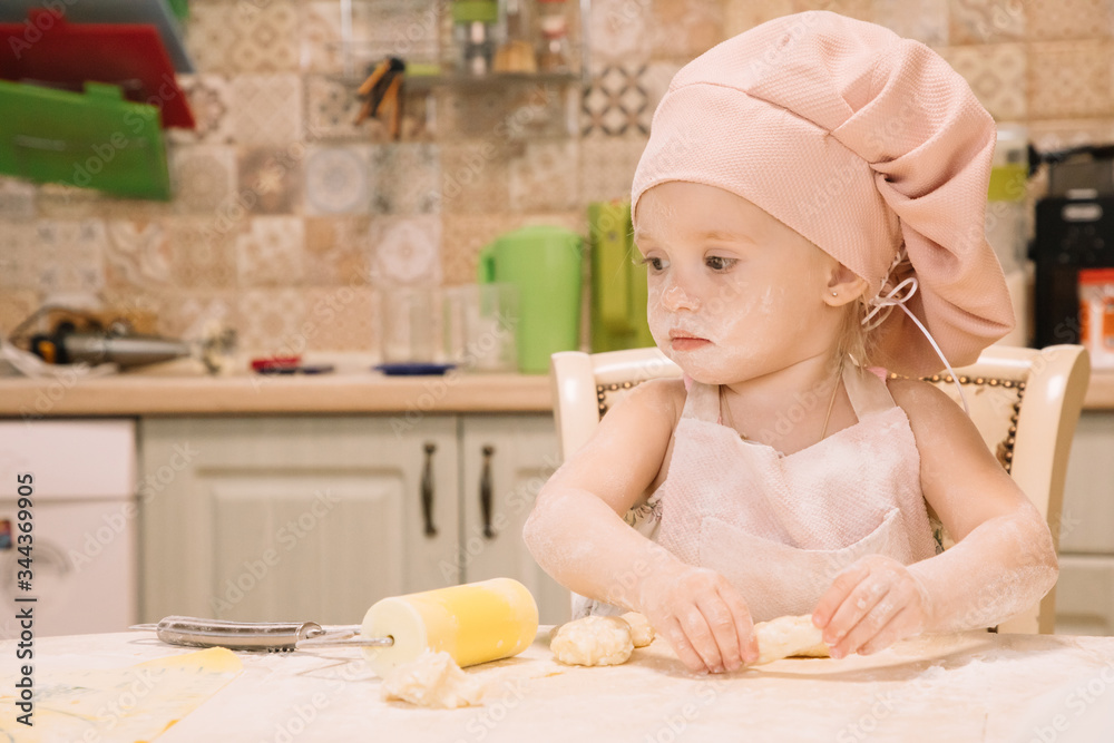 Little girl cooks at home in the kitchen Little girl cooks at home in the kitchen