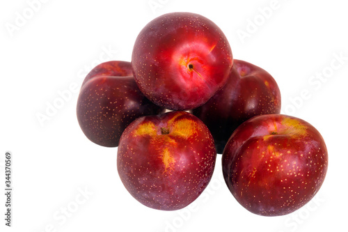 Ripe sweet juicy plums on an isolated white background.