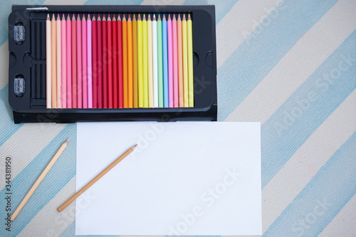colorful pencil in box on floor with mock up white paper