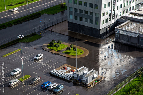 View of the car Park from above after the rain. Wet buildings and streets.