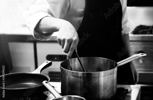 Chef cooking in a kitchen, chef at work, Black & White.