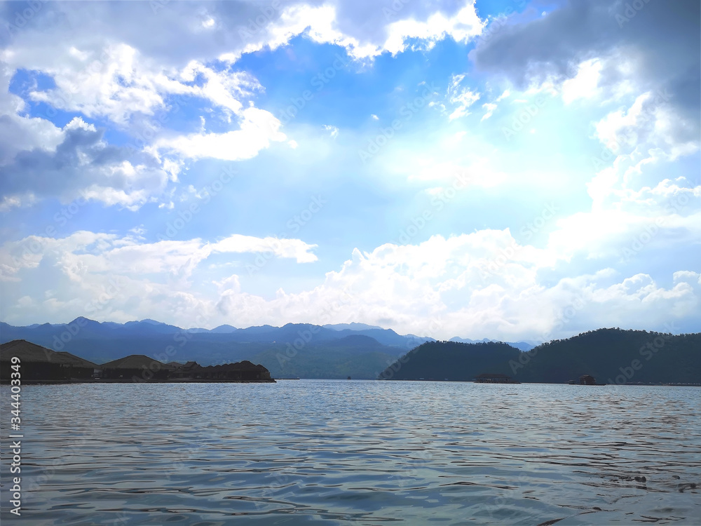 Landscape of the mountain and river with blue sky in the morning. View of the mountain with blue sky at Srinakarin Dam , Kanchanaburi province , Thailand. Landscape of the mountain and river with blue sky in the morning. View of the mountain with blue sky at Srinakarin Dam , Kanchanaburi province , Thailand.