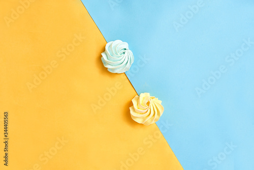Blue and yellow meringue on a blue and yellow background