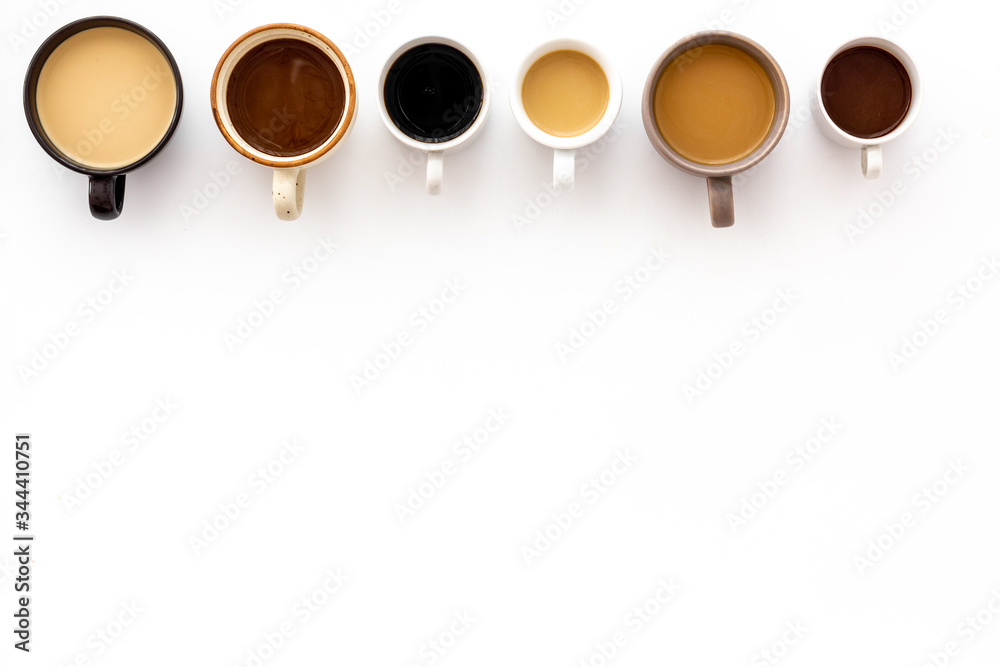 Cups of hot drinks on white background from above frame copy space