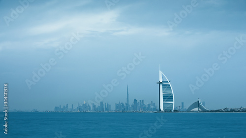 Viewing Dubai cityscape with Jumeirah coast and Downtown across the sea on a moody cloudy day. Dubai, United Arab Emirates. © Kertu